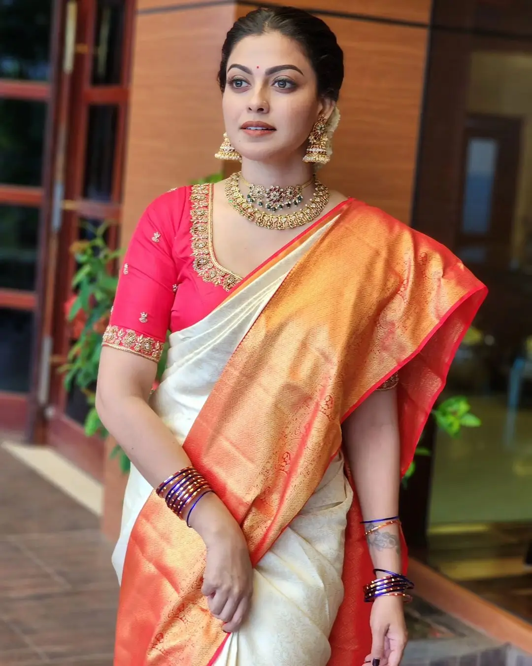 Anusree Nair Wearing Beautiful Earrings Jewellery White Saree Orange Blouse